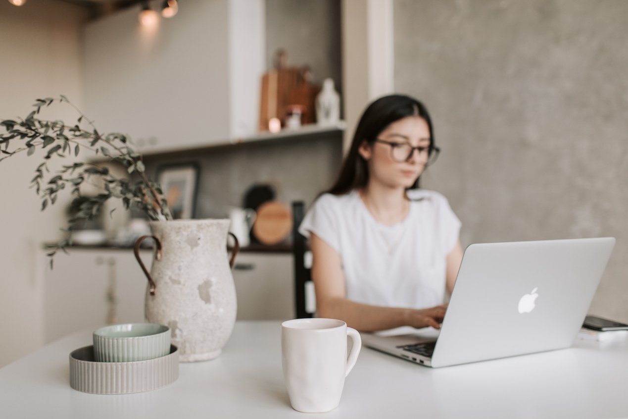 Focused young businesswoman working remotely at home